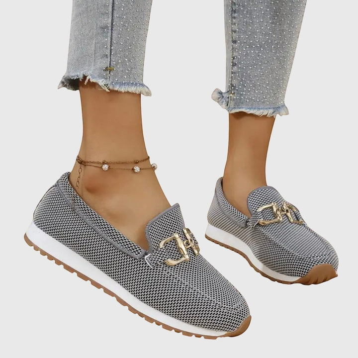 Nora & Elise grey mesh orthopaedic moccasin trainers with gold horseshoe detail and white sole.
