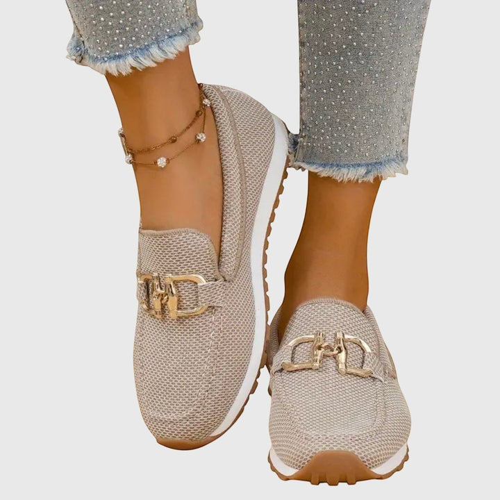 Nora & Elise Susie beige mesh orthopaedic moccasin trainers with gold buckle detail and white sole.