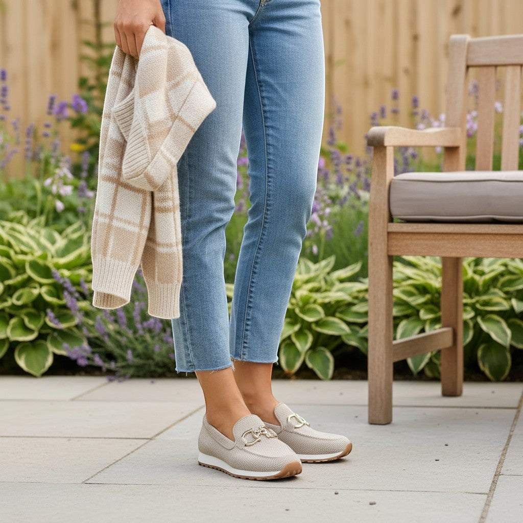Nora & Elise Susie light beige orthopaedic moccasin trainers with gold horseshoe detail and non-slip sole.