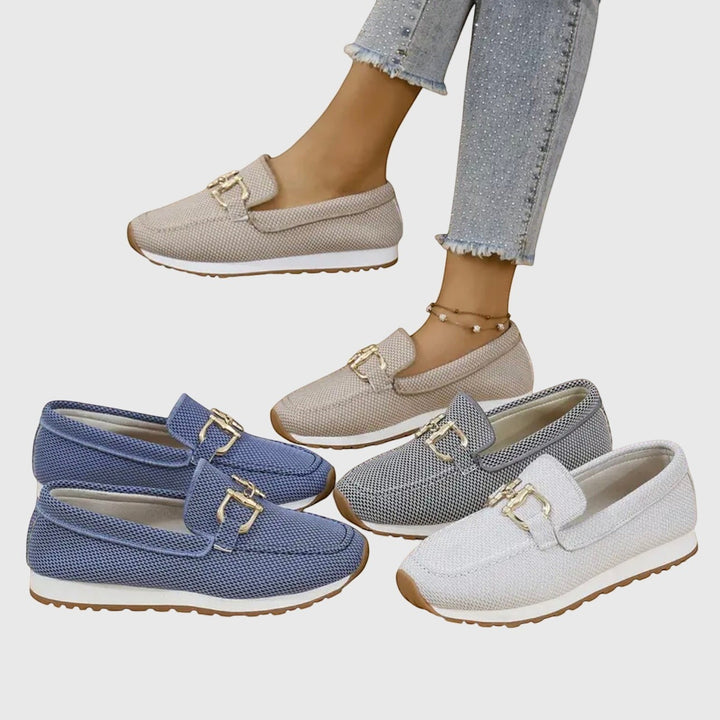 Nora & Elise Susie orthopaedic moccasin trainers in beige, blue, grey, and light blue mesh with gold horseshoe detail and non-slip sole.